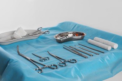 Different surgical instruments on table against light background
