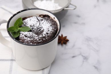 Photo of Tasty chocolate mug pie on white marble table, space for text. Microwave cake recipe