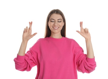 Woman with crossed fingers on white background. Superstition concept