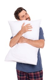 Handsome man hugging soft pillow on white background