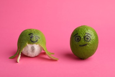 Limes with drawn faces on pink background. Exhibitionist concept
