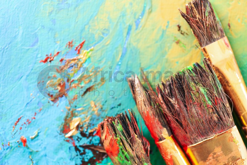 Abstract colorful artwork and brushes, closeup view