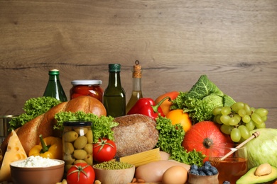 Different products on wooden background, closeup. Healthy food and balanced diet