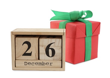 Wooden block calendar with Boxing Day date and Christmas gift on white background