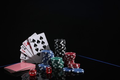 Casino chips, dice and playing cards on dark background, space for text. Full house poker combination