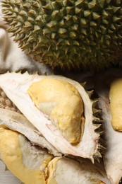 Fresh ripe durian fruits on table, closeup