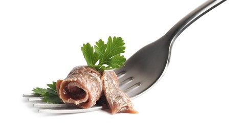 Photo of Fork with delicious anchovy fillet and parsley isolated on white