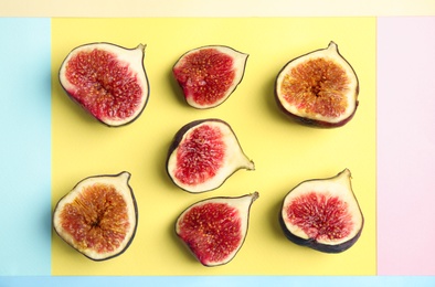 Delicious ripe figs on color background, flat lay