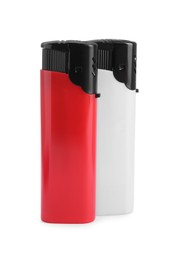 Photo of Stylish small pocket lighters on white background