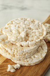 Crunchy rice cakes on wooden board, closeup