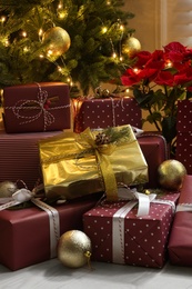 Many different gifts under Christmas tree indoors