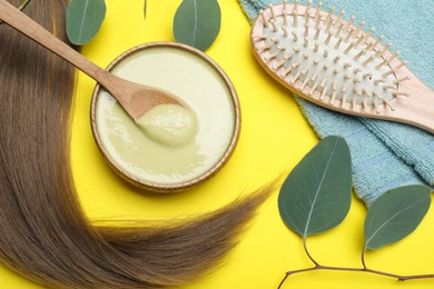 Photo of Flat lay composition with homemade hair mask and ingredients on yellow background
