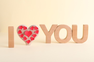 Phrase I Love You made of wooden letters on light background