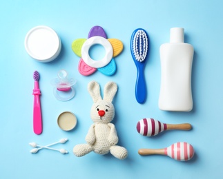Flat lay composition with baby accessories and toys on color background