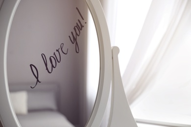 Words I Love You written on mirror indoors