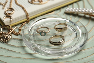 Stylish golden bijouterie on table, closeup. Elegant accessories
