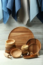 Photo of Set of clean wooden dishware and utensils on table