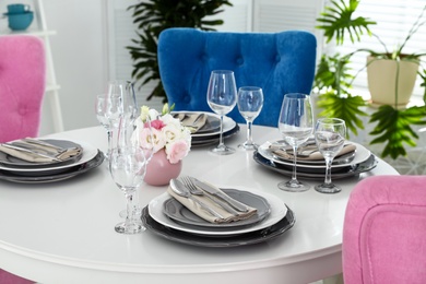 Beautiful table setting in modern dining room interior