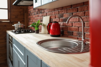 Stylish sink in modern kitchen. Home interior design