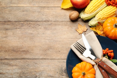 Flat lay composition with tableware, autumn fruits and vegetables on wooden background, space for text. Thanksgiving Day