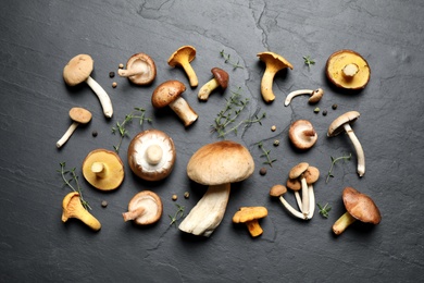 Flat lay composition with fresh mushrooms, thyme and pepper on grey background