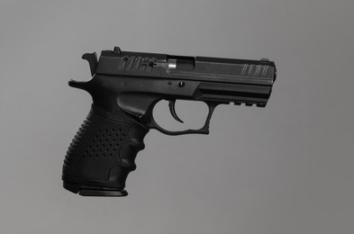 Standard handgun on light grey background. Semi-automatic pistol