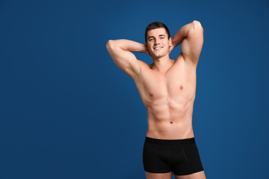 Man with sexy body on blue background