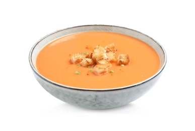 Tasty creamy pumpkin soup with croutons in bowl on white background