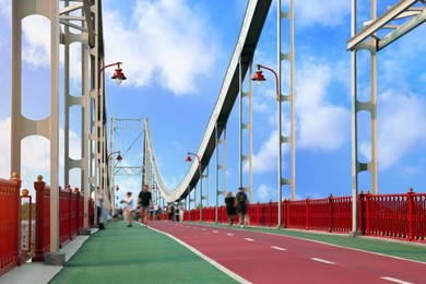 KYIV, UKRAINE - AUGUST 11, 2022: Beautiful pedestrian bridge on summer day