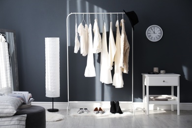 Dressing room interior with clothing rack and floor lamp