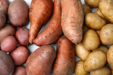 Photo of Different types of fresh potatoes on white table, top view