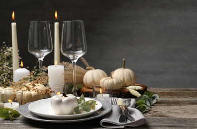 Beautiful autumn place setting and decor on wooden table, space for text