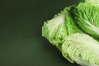 Fresh ripe Chinese cabbages on green background, above view. Space for text