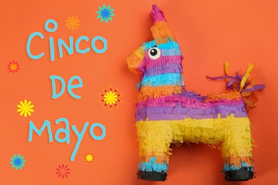 Image of Cinco de Mayo festive poster. Bright funny pinata on orange background, top view
