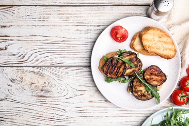 Photo of Delicious eggplant sandwiches served on white wooden table, flat lay. Space for text