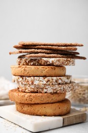 Stack of rye crispbreads, rice cakes and rusks on table, closeup