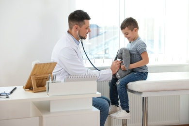 Children's doctor working with little patient in clinic