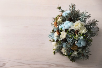Beautiful wedding winter bouquet on white wooden table, top view. Space for text