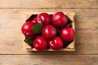 Fresh ripe cherry plums on wooden table, top view