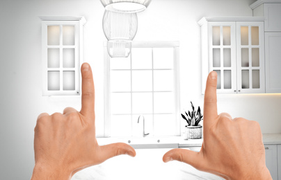 Image of Woman showing frame gesture and making kitchen real out of drawing