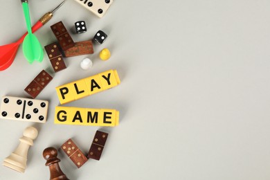 Flat lay composition of blocks with words Play Game on grey background. Space for text
