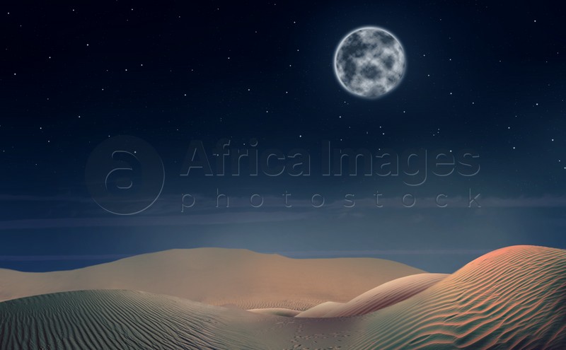 Scenic view of sandy desert under starry sky with full moon in night 