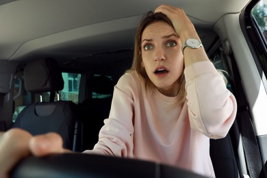 Stressed woman in driver's seat of modern car