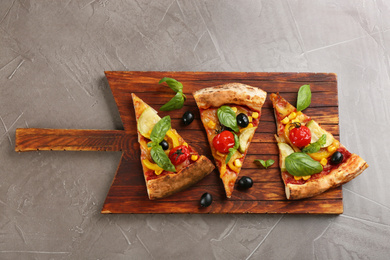 Photo of Delicious vegetable pizza on grey table, top view