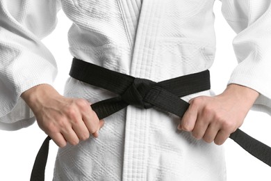 Karate coach wearing kimono and black belt on white background, closeup