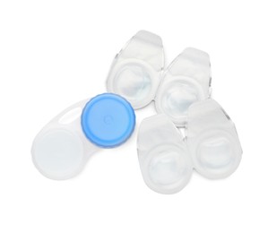 Packages with contact lenses and case on white background, top view