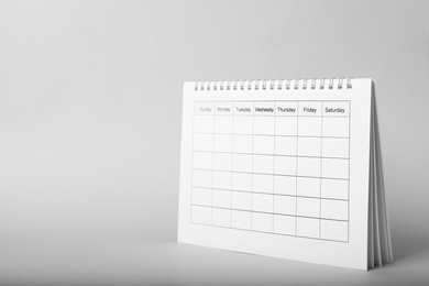 Blank paper calendar on grey background, space for text. Planning concept