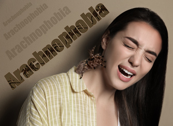 Scared woman with tarantula on beige background. Arachnophobia (fear of spiders)