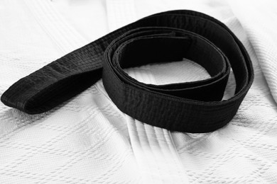 Photo of Black belt on white kimono, closeup view