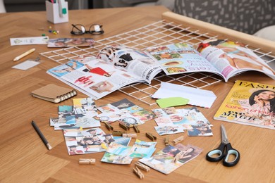 Composition with different photos, magazines and metal grid on wooden table indoors. Creating vision board